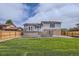 View of the home's backyard featuring a well-kept lawn and a deck with access to the home at 450 Lone Pine St, Fort Lupton, CO 80621