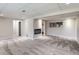 Finished basement featuring neutral walls, plush carpet, and a modern electric fireplace at 450 Lone Pine St, Fort Lupton, CO 80621
