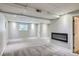 Finished basement featuring a modern fireplace and neutral carpeting at 450 Lone Pine St, Fort Lupton, CO 80621