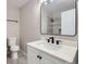 Bathroom featuring a sleek vanity, contemporary fixtures, and a well-lit mirror at 450 Lone Pine St, Fort Lupton, CO 80621