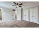 Cozy bedroom featuring plush carpet, neutral walls, a ceiling fan, and closet space at 450 Lone Pine St, Fort Lupton, CO 80621