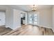Dining room with light hardwood floors open to the kitchen and a set of French doors leading to the backyard at 450 Lone Pine St, Fort Lupton, CO 80621