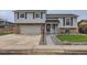 Charming two-story home featuring an attached two-car garage, well-maintained lawn, and inviting entryway at 450 Lone Pine St, Fort Lupton, CO 80621