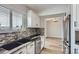 Modern kitchen boasting white cabinets, stainless steel appliances, stylish backsplash, and sleek countertops at 450 Lone Pine St, Fort Lupton, CO 80621