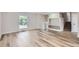 Bright and spacious living area featuring light hardwood floors, a large window and built in shelves at 450 Lone Pine St, Fort Lupton, CO 80621