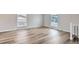 Bright and spacious living area featuring light hardwood floors and large windows, allowing ample natural light at 450 Lone Pine St, Fort Lupton, CO 80621