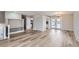 Bright and spacious living area featuring light hardwood floors, and ample space for entertaining at 450 Lone Pine St, Fort Lupton, CO 80621