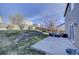 This backyard features an entertainment space and grass area at 10061 Apollo Bay Way, Highlands Ranch, CO 80130