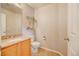 Cozy half bathroom with decorative shelves, modern toilet, and a granite countertop vanity at 10061 Apollo Bay Way, Highlands Ranch, CO 80130