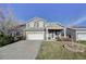Charming two-story home with a well-maintained front yard and inviting covered porch at 10061 Apollo Bay Way, Highlands Ranch, CO 80130