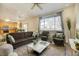 Comfortable living room with ample seating, lots of light, and open kitchen view at 10061 Apollo Bay Way, Highlands Ranch, CO 80130