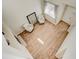 View from above into the living room with hardwood floors and decoratively framed art piece at 10061 Apollo Bay Way, Highlands Ranch, CO 80130