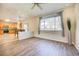 Bright living room with sleek floors, lots of light, and open kitchen view at 10061 Apollo Bay Way, Highlands Ranch, CO 80130