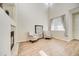 Vaulted living room with fireplace, large window, and two accent chairs at 10061 Apollo Bay Way, Highlands Ranch, CO 80130