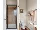 Bathroom featuring tiled shower, neutral walls, and warm lighting at 4473 Echo Dr, Larkspur, CO 80118