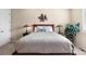 Comfortable bedroom with a wooden headboard, decorated with a tree-themed decor at 4473 Echo Dr, Larkspur, CO 80118