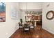 Cozy dining area adjacent to kitchen featuring hardwood floors and bright natural light at 4473 Echo Dr, Larkspur, CO 80118