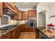 Gourmet kitchen with custom cabinetry, granite counters, stainless steel appliances, and hardwood floors at 4473 Echo Dr, Larkspur, CO 80118