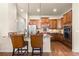 Well-equipped kitchen with stainless steel appliances, granite countertops, and a breakfast bar at 4473 Echo Dr, Larkspur, CO 80118