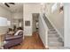 Inviting living room flows into dining space with hardwood floors and staircase to the upper level at 4473 Echo Dr, Larkspur, CO 80118