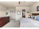 Charming main bedroom with ceiling fan, carpet, ensuite bathroom, and large dresser at 4473 Echo Dr, Larkspur, CO 80118