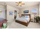Cozy main bedroom boasts a ceiling fan, ensuite bathroom, and great natural light at 4473 Echo Dr, Larkspur, CO 80118