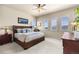Spacious main bedroom featuring a ceiling fan, carpet, and views from multiple windows at 4473 Echo Dr, Larkspur, CO 80118