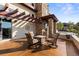 Outdoor patio includes comfortable seating and a beautiful stone accent wall at 4473 Echo Dr, Larkspur, CO 80118