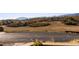 Scenic view of a parking area with colorful vegetation and mountains in the background on a bright day at 4473 Echo Dr, Larkspur, CO 80118
