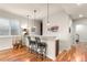 Basement bar area with bar stool seating, decorative pendant lights, and access to another room at 4473 Echo Dr, Larkspur, CO 80118