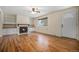 Hardwood floors and a fireplace highlight this spacious living room at 7038 Otis Ct, Arvada, CO 80003