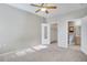 Neutral bedroom with carpeted floor and ceiling fan; door to en suite bathroom at 16312 E Fremont Ave # 6, Aurora, CO 80016