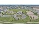 Aerial view of community park with playground, sports fields, and green spaces at 4589 Quandary Peak St, Brighton, CO 80601