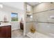 Bright bathroom showcasing a glass-enclosed shower with tiled walls and built-in shelves at 4589 Quandary Peak St, Brighton, CO 80601