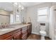 Bathroom featuring double sinks with granite countertops and dark wood cabinets, providing ample space and storage at 4589 Quandary Peak St, Brighton, CO 80601