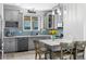 Modern kitchen featuring gray cabinets, stainless steel appliances, tile backsplash, and an island with seating at 4589 Quandary Peak St, Brighton, CO 80601