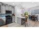 Stylish kitchen and dining area featuring modern finishes, gray cabinets, and stainless steel appliances at 4589 Quandary Peak St, Brighton, CO 80601