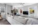 Inviting living room with a fireplace, wet bar, and large sectional sofa perfect for entertaining at 4589 Quandary Peak St, Brighton, CO 80601