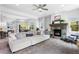 Open-concept living space with a fireplace, comfortable seating, and plenty of natural light, seamlessly connected to the kitchen at 4589 Quandary Peak St, Brighton, CO 80601