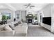 Bright living room features a cozy fireplace, large sectional sofa, and ample natural light at 4589 Quandary Peak St, Brighton, CO 80601
