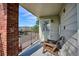 Balcony area with chairs, brick accent wall, and scenic views of the street and mountains at 1629 S Deframe St # B8, Lakewood, CO 80228