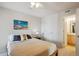 Cozy bedroom showcasing a comfortable bed, ceiling fan, and en-suite bathroom at 1629 S Deframe St # B8, Lakewood, CO 80228