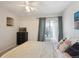 Bright bedroom featuring a ceiling fan, comfy bed, and sliding glass doors to a patio at 1629 S Deframe St # B8, Lakewood, CO 80228