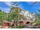 Multi-level condo featuring brick accents, upper level balconies, and well-maintained landscaping at 1629 S Deframe St # B8, Lakewood, CO 80228