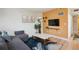 The living room boasts a cozy seating area, hardwood floors, and a modern entertainment setup at 1629 S Deframe St # B8, Lakewood, CO 80228
