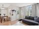 Inviting living room area featuring a cozy couch, bright window, and adjacent dining space at 1629 S Deframe St # B8, Lakewood, CO 80228