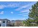 Scenic view showcasing clear blue skies, distant mountains, and surrounding neighborhood trees at 1629 S Deframe St # B8, Lakewood, CO 80228