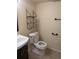 Bathroom showcasing the toilet, a decorative shelf, and a sink at 15703 E 13Th Pl, Aurora, CO 80011