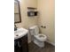Bathroom featuring modern sink, toilet, and black shelving at 15703 E 13Th Pl, Aurora, CO 80011