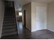 Inviting entryway with wood-look flooring, staircase, and access to the kitchen at 15703 E 13Th Pl, Aurora, CO 80011